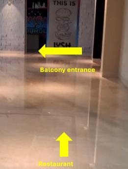 Wayfinding arrows directing towards balcony and restaurant