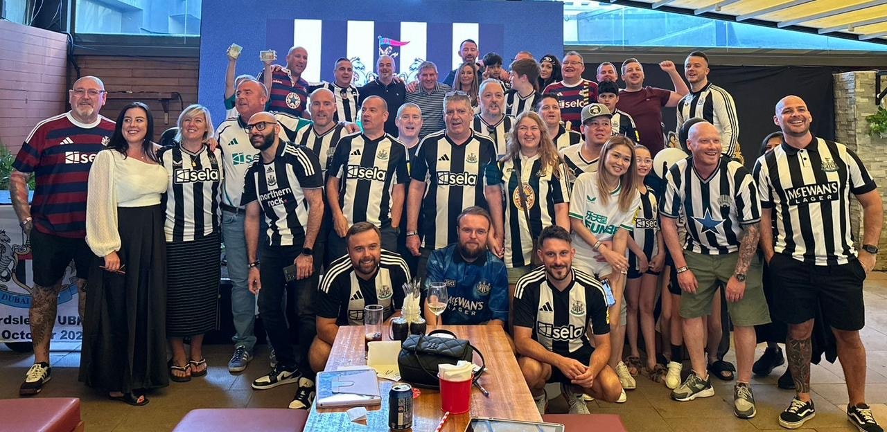 Dubai Mags group photo in Newcastle United kits